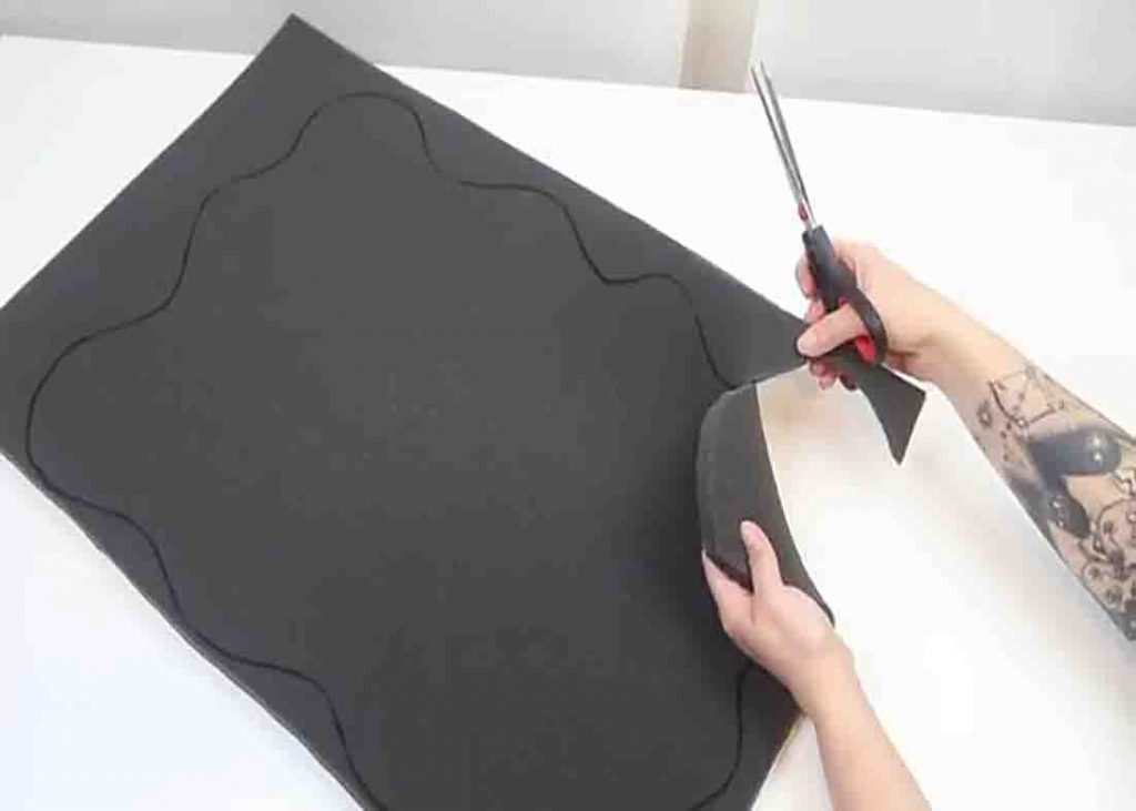 Cutting out the foam in the shape of the bath mat