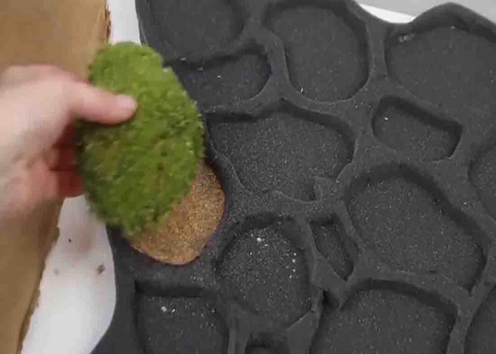 Placing the moss pieces in the DIY bath mat