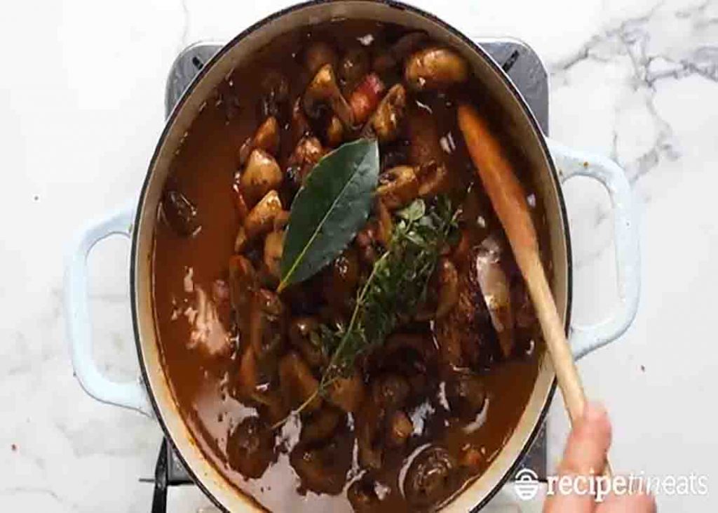 Cooking the french chicken stew in red wine sauce