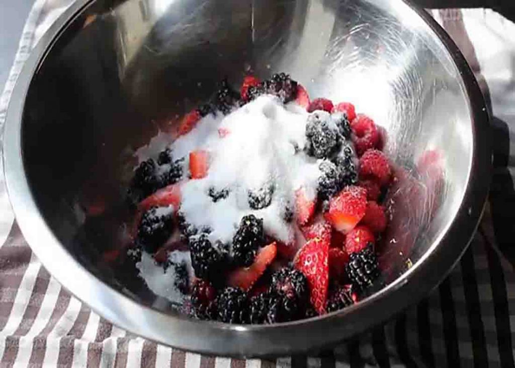 Mixing different berries for the fresh berry fool dessert recipe