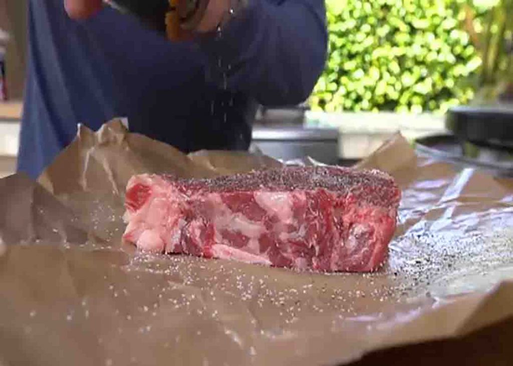 Seasoning the steak for the sandwich recipe