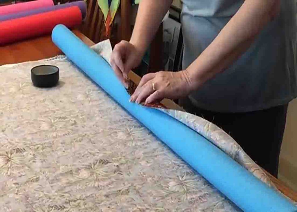 Rolling the backing fabric on the pool noodle