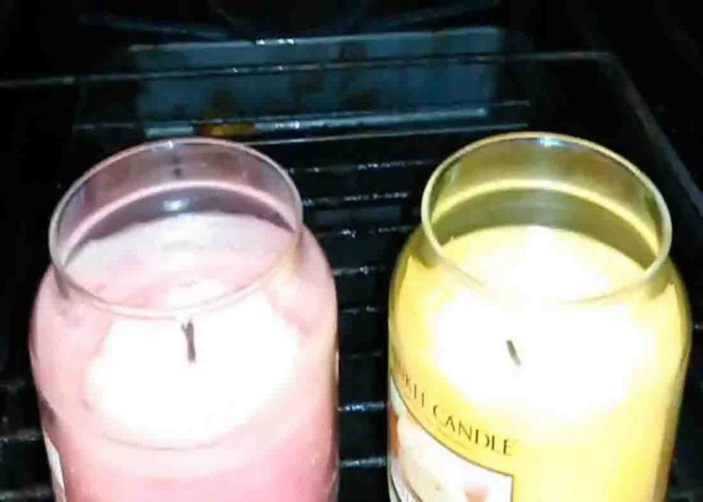 Placing the candles inside the oven to melt the tunneled part