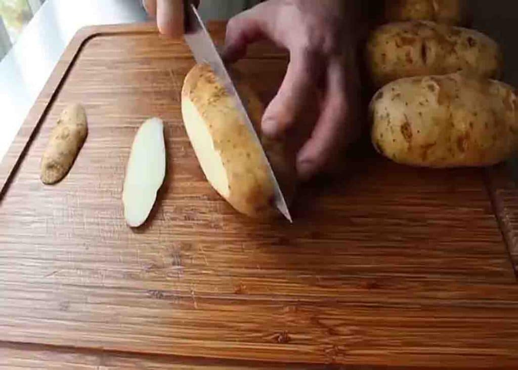 Cutting the potatoes in half