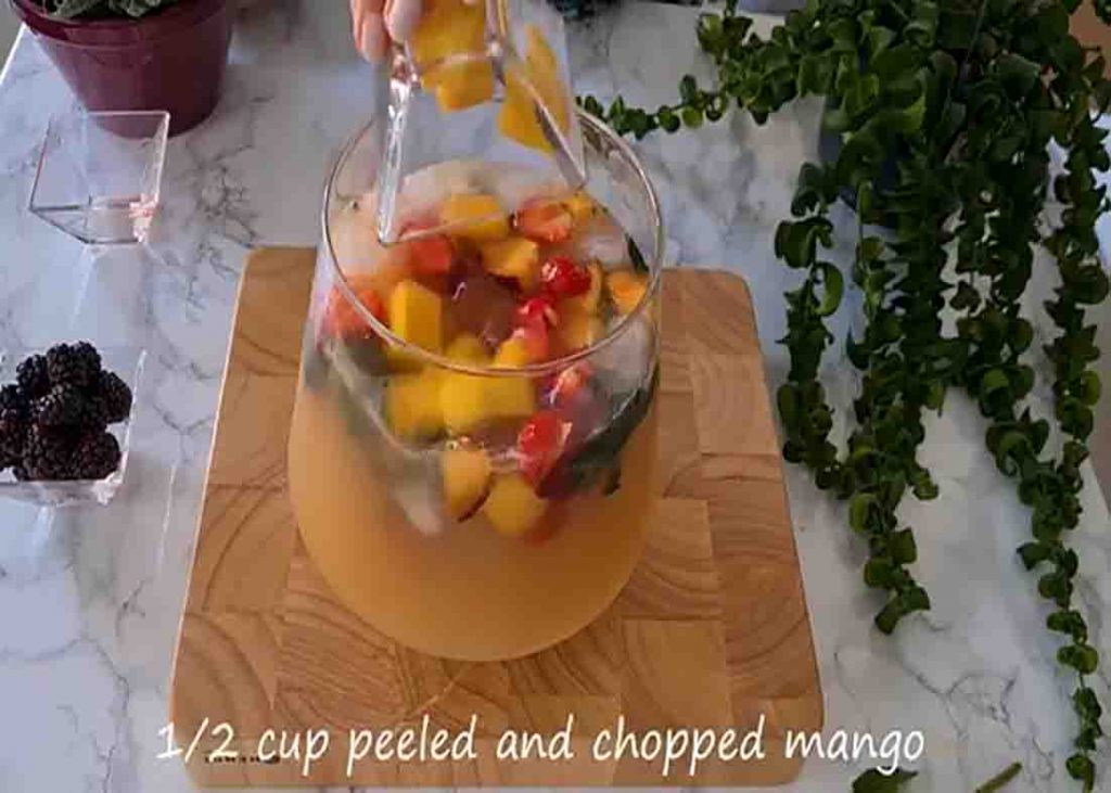 Combining all the ingredients for the non-alcoholic fruit punch