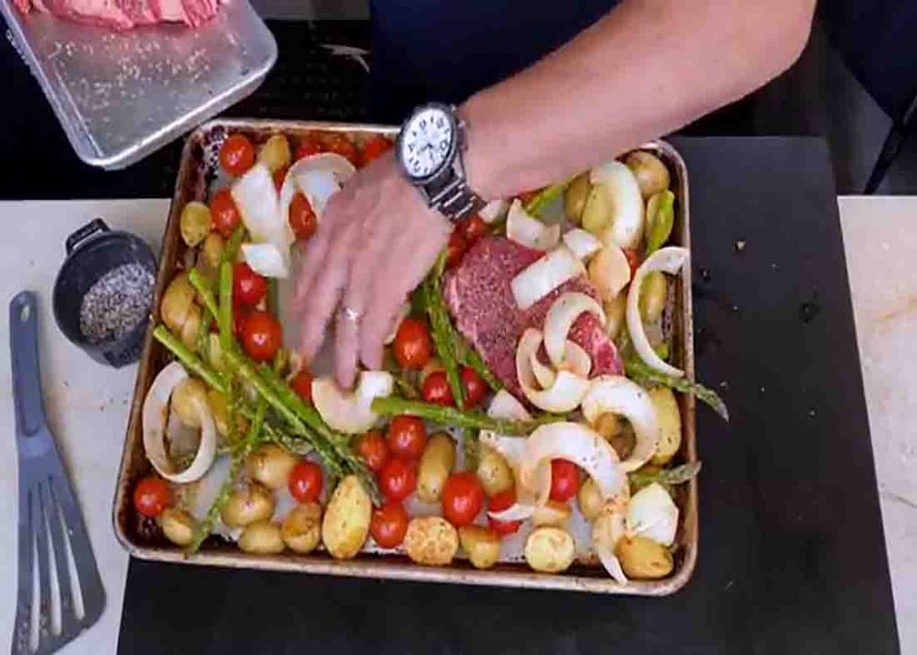 Arranging the steak and veggies on the sheet pan