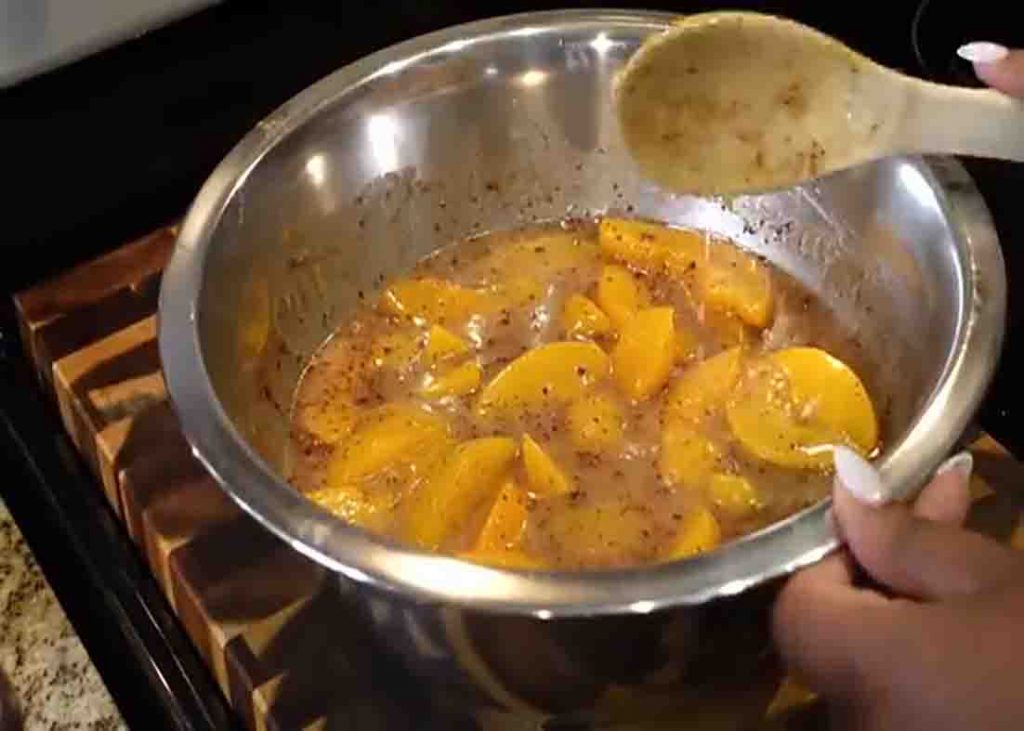 Combining all the ingredients for the peach cobbler recipe