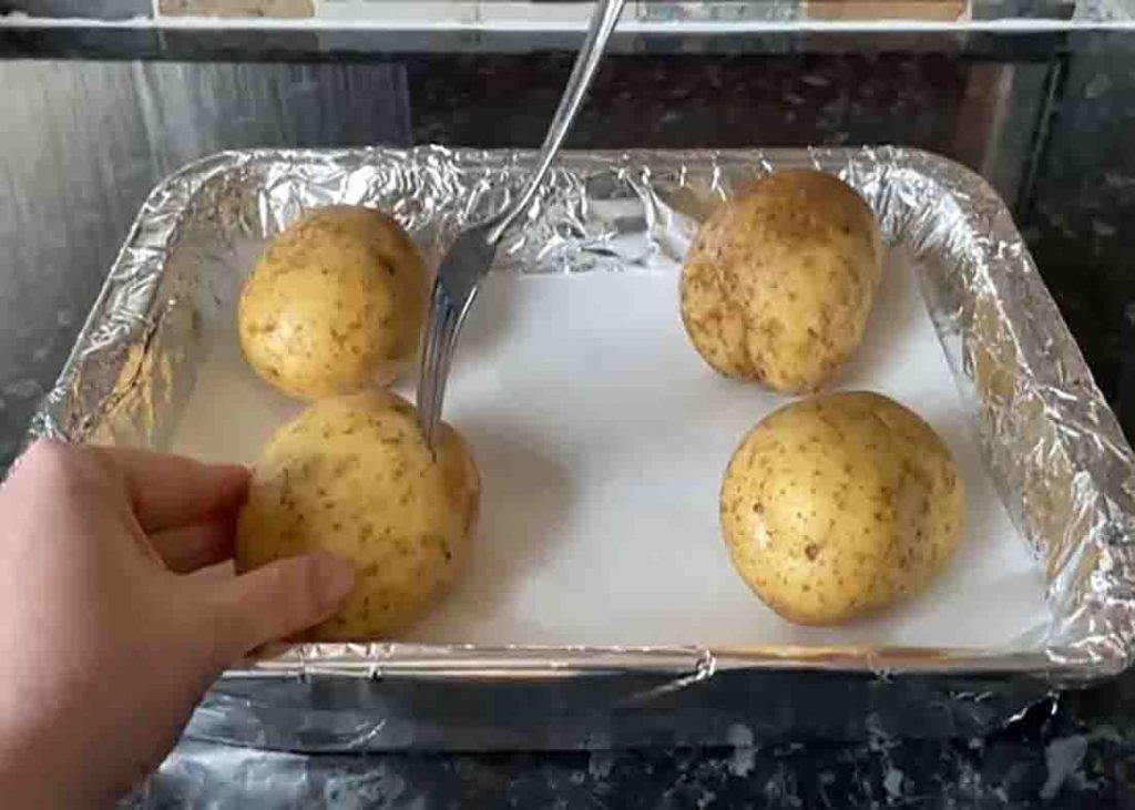 Pricking holes to the potatoes before baking