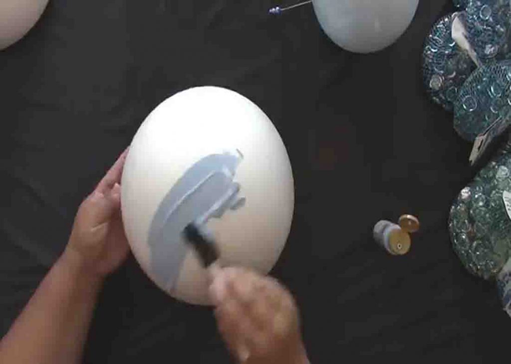 Painting the foam ball blue for the faux garden globe