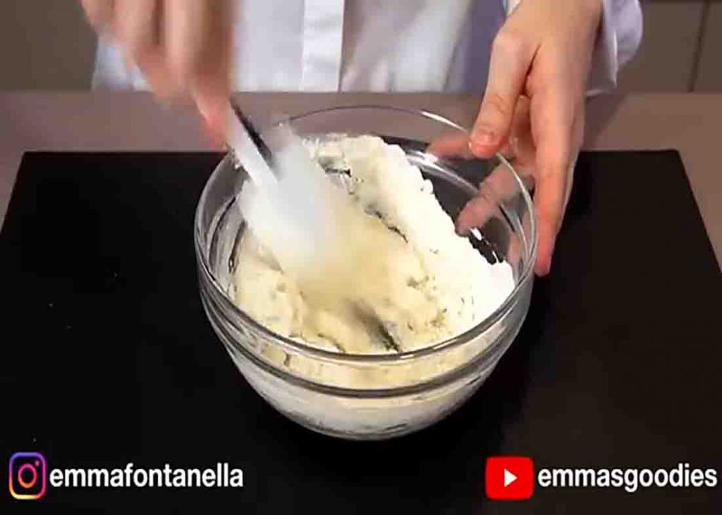 Mixing the ingredients to form the pizza dough