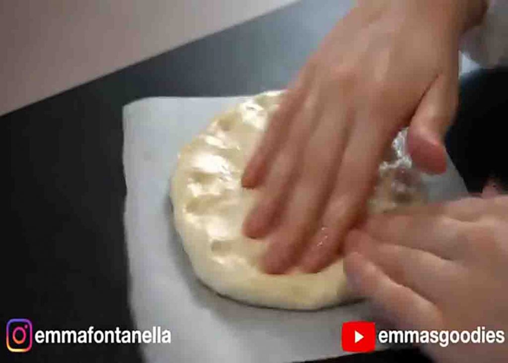 shaping the dough into a pizza