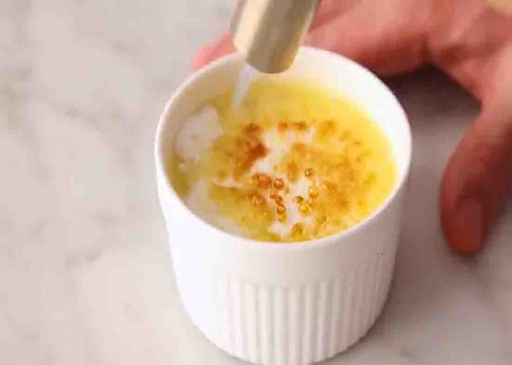 Blow torching the surface of the creme brulee