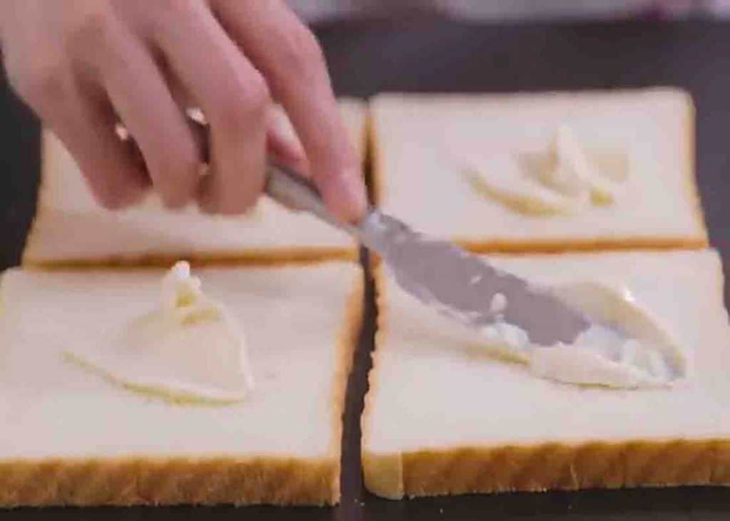 Spreading the mayonnaise on the bread slices