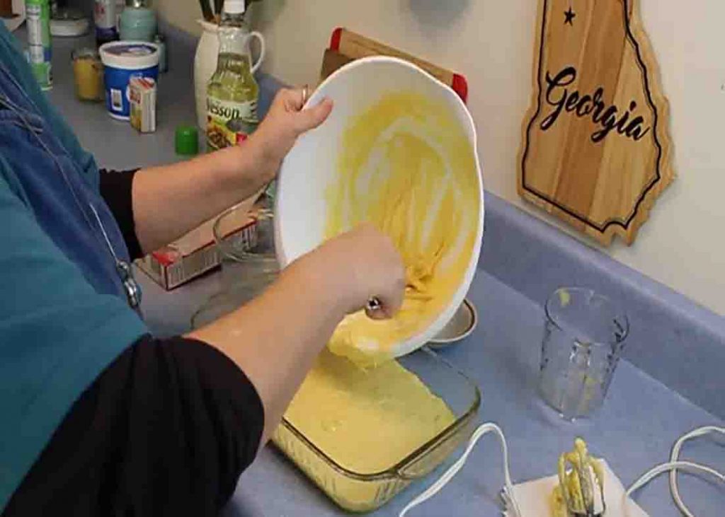 Adding the cake batter into the baking pan