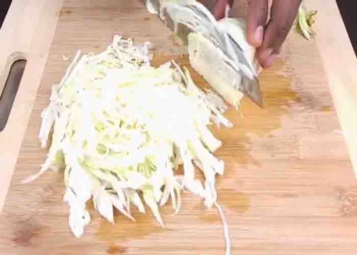 Shredding the cabbage for the cabbage salad recipe