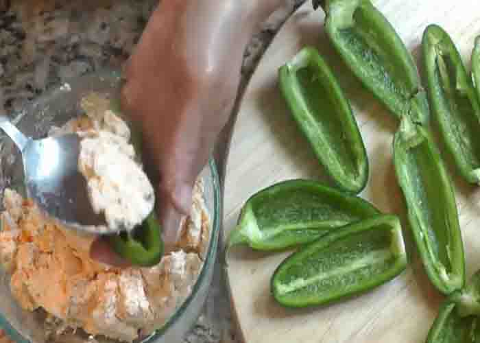 Stuffing the jalapeno with the cream cheese mixture