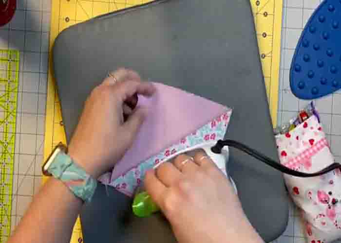 Pressing down the half-square triangle unit for the betty quilt block