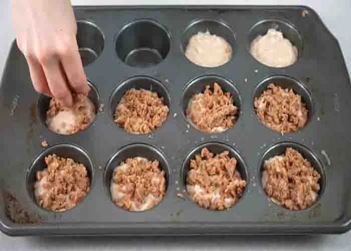 Dividing the cinnamon coffee muffin batter to the muffin pan