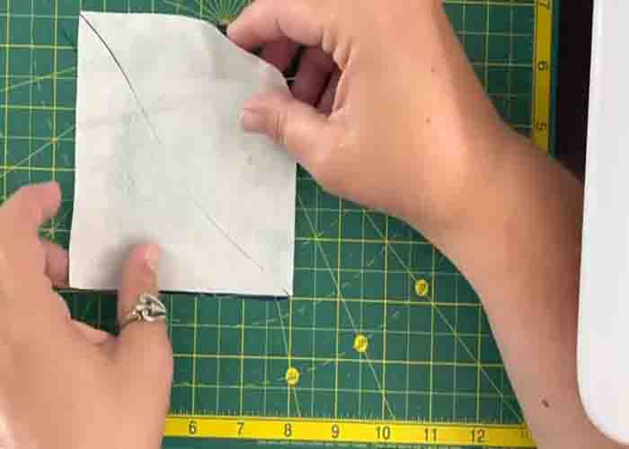 Cutting the block in curve to make the ocean waves quilt block