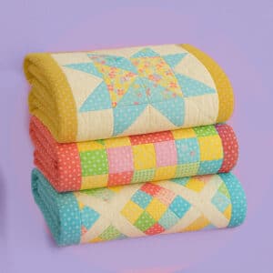 Colorful quilt in progress with fabric pieces, quilting tools, and a step-by-step pattern layout.