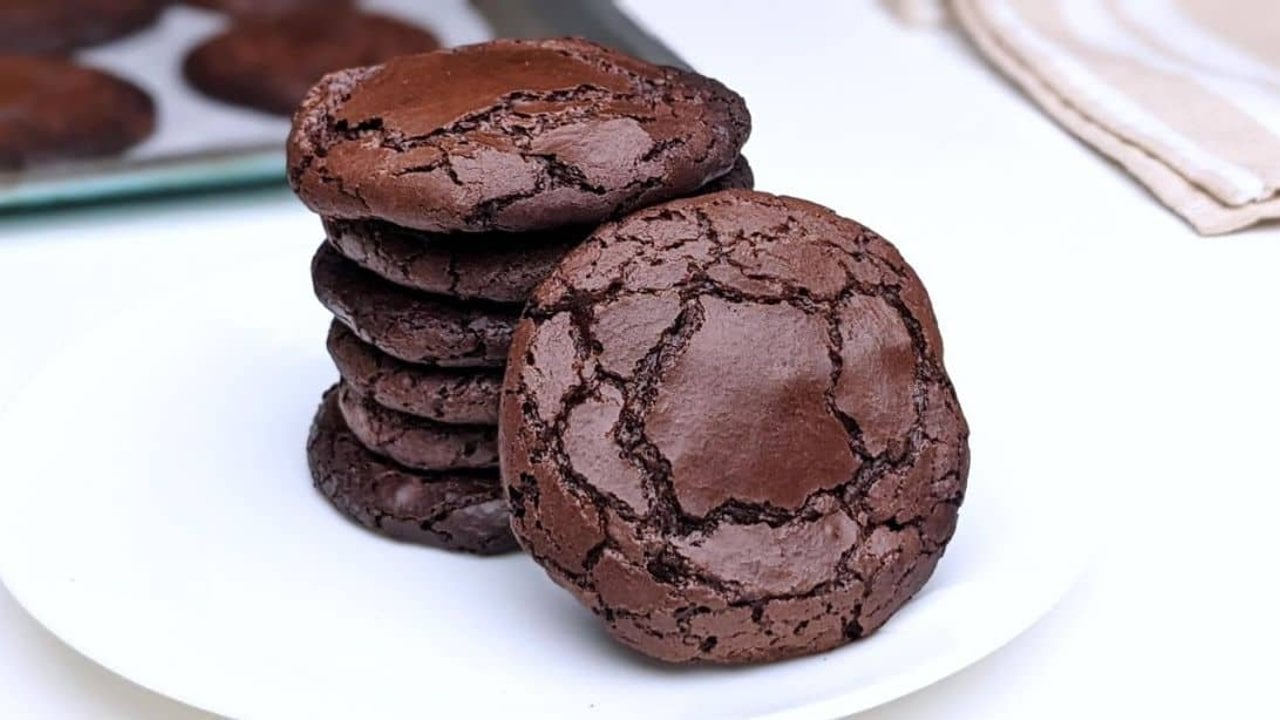 3 Ingredient Chocolate Cookies Recipe Three ingredient chocolate cookies with crackled tops stacked on a white plate, a simple flourless treat