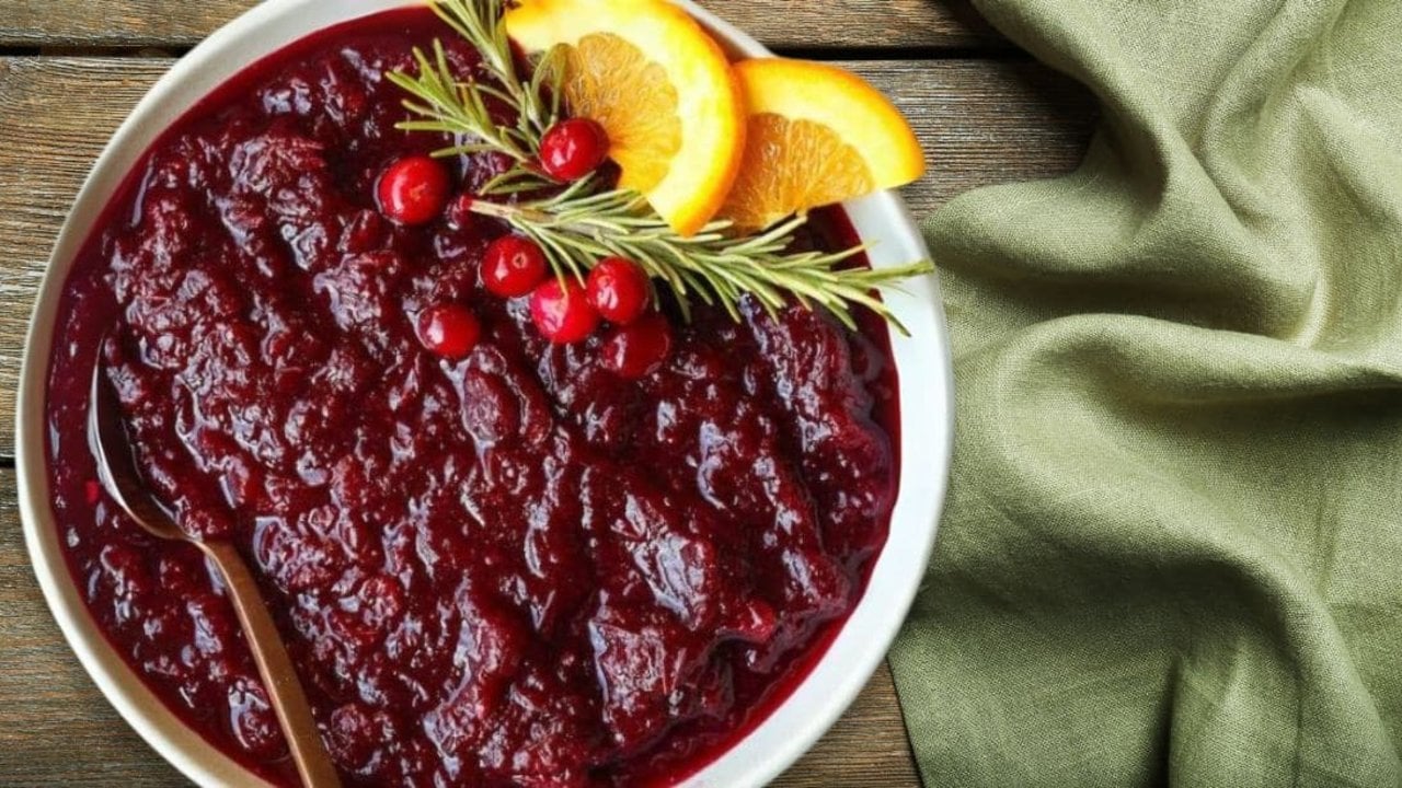 4 Ingredient Cranberry Jam Recipe Four ingredient cranberry jam in a glass jar, deep red and thick, made with fresh cranberries and citrus juice