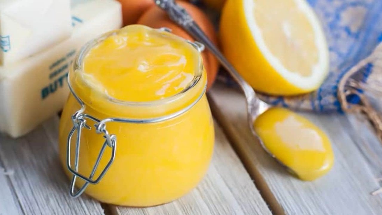 Homemade lemon curd in a jar, thick and glossy, made from lemon juice, eggs, sugar, butter and vanilla