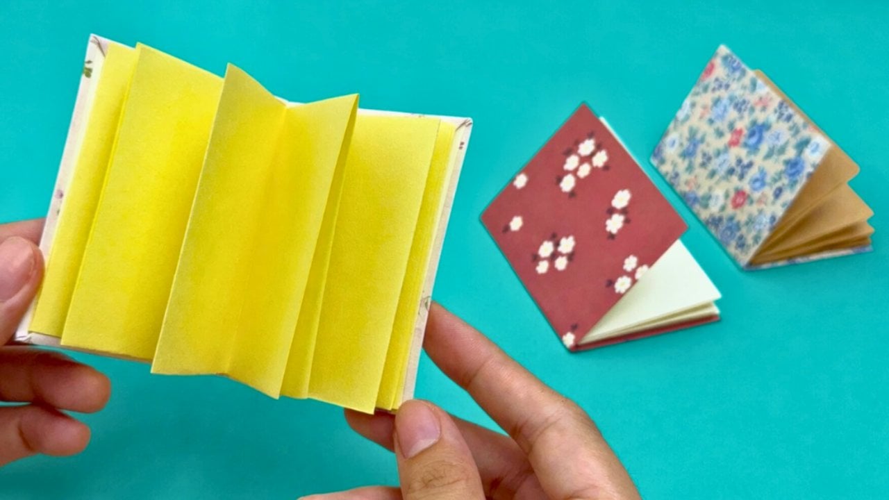 Mini notebook DIY made from leftover patterned scrapbook paper, folded small enough to fit in a pocket or bag