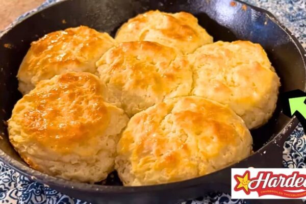 Stack of golden, flaky homemade copycat Hardee's biscuits on a plate, an easy Southern-style from-scratch breakfast recipe.