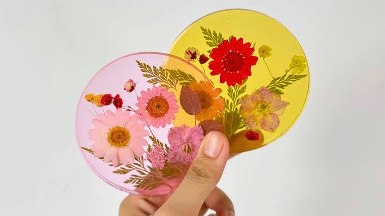 Clear resin coaster with real dried flowers pressed inside, a beginner friendly resin craft to make and sell