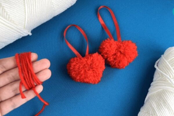 How to Make Pom Pom Hearts — easy step-by-step DIY tutorial.