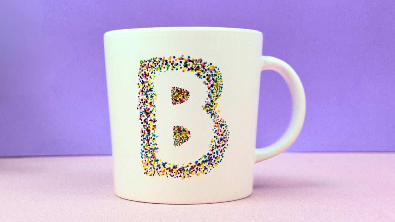 Plain white mug hand decorated with a Sharpie letter pattern as a personalized handmade gift to make at home