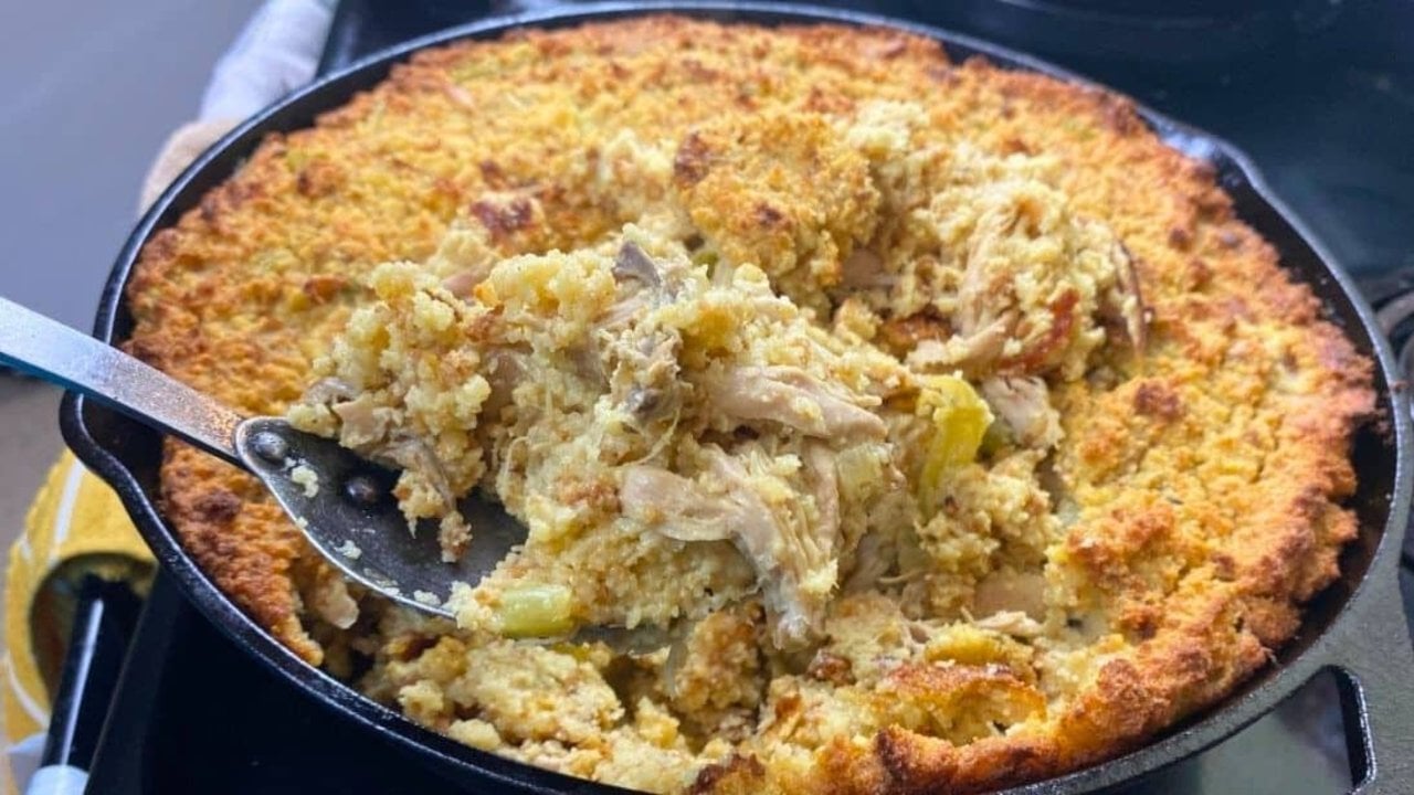 Southern cornbread chicken and dressing baked golden brown in a casserole dish and scooped onto a plate