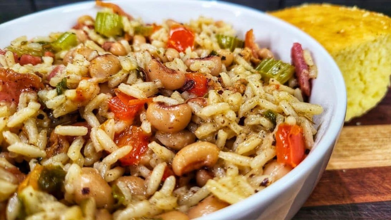 Southern Hoppin' John in a bowl with black eyed peas, rice, bacon pieces, celery and red bell pepper