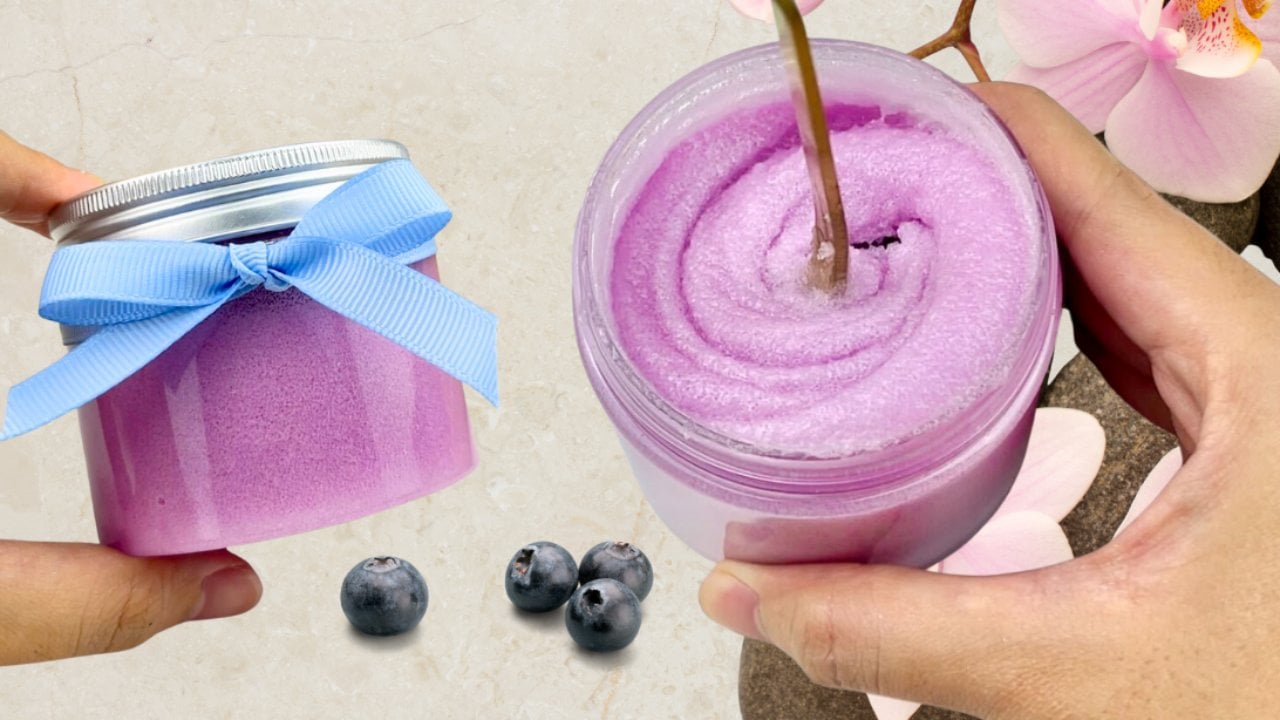 Homemade blueberry sugar scrub packed in a small glass jar, an easy bath and body product to make and sell