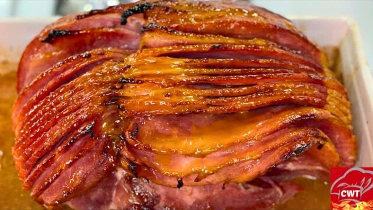Brown sugar honey glazed ham, a spiral cut ham with deeply caramelized glazed edges in a roasting dish