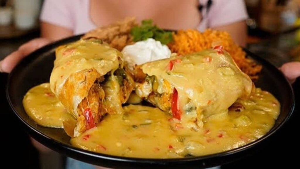 Cheesy Chicken Chimichangas With Green Chile Queso Sauce, homemade and freshly served