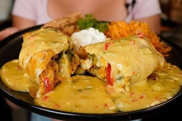 Cheesy Chicken Chimichangas With Green Chile Queso Sauce, homemade and freshly served