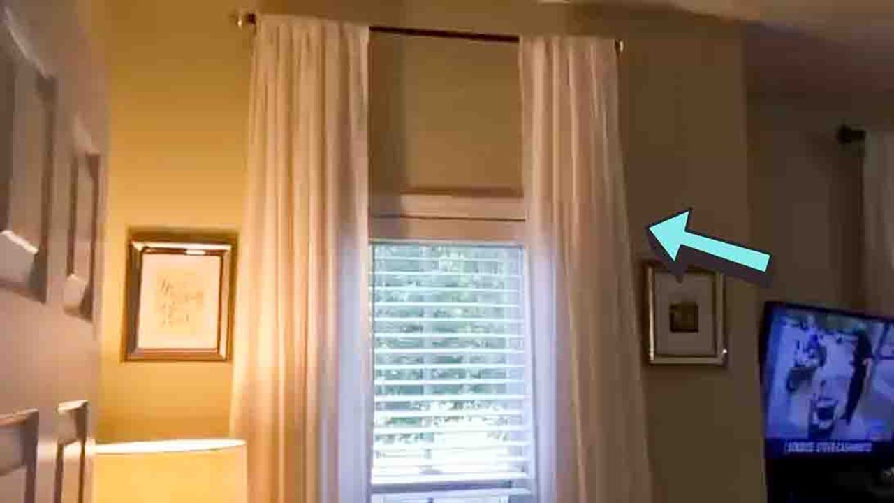 DIY curtains made out of twin flat sheets hanging at a window, an easy five minute no sew window treatment