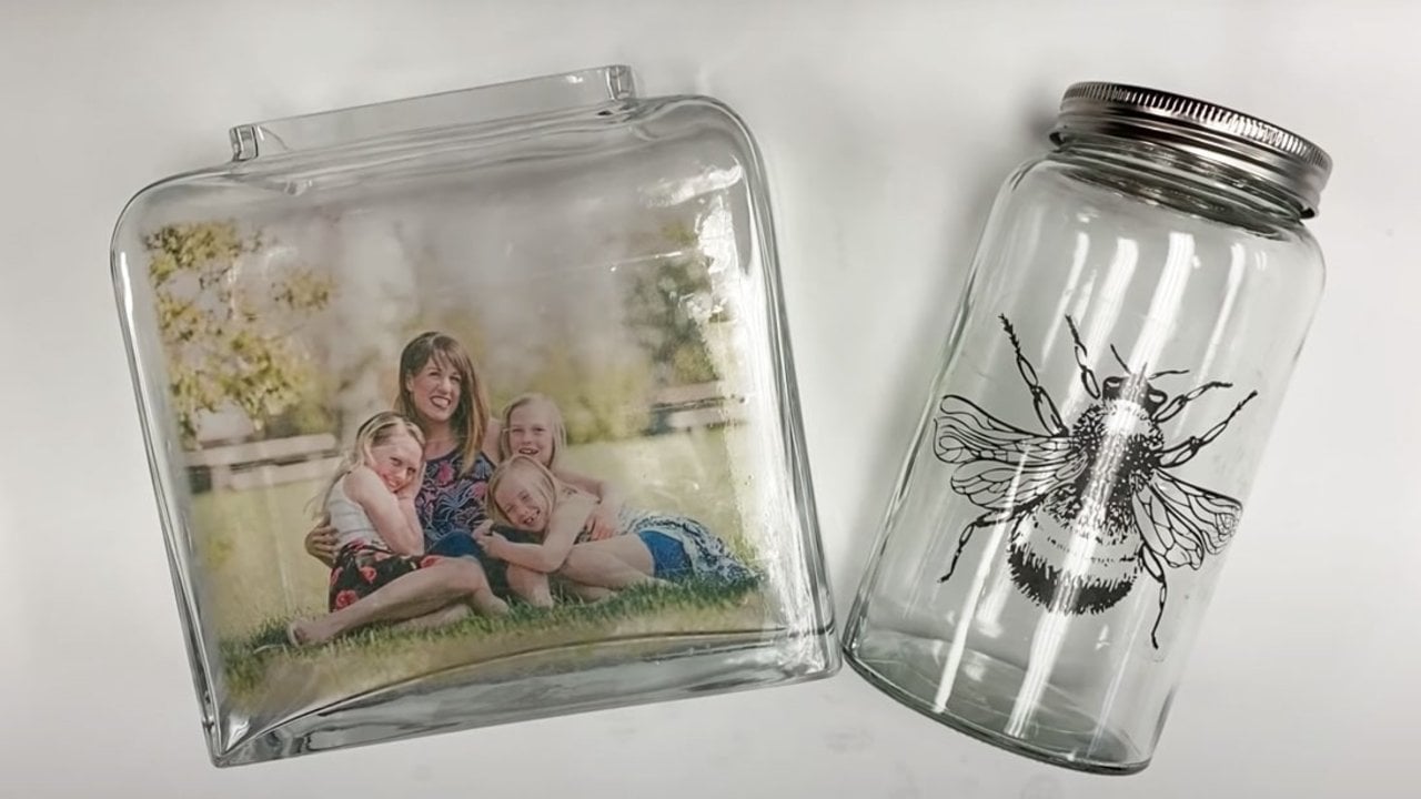 DIY photo transfer on glass using packing tape, a family photo transferred onto a glass jar beside a jar with a bee