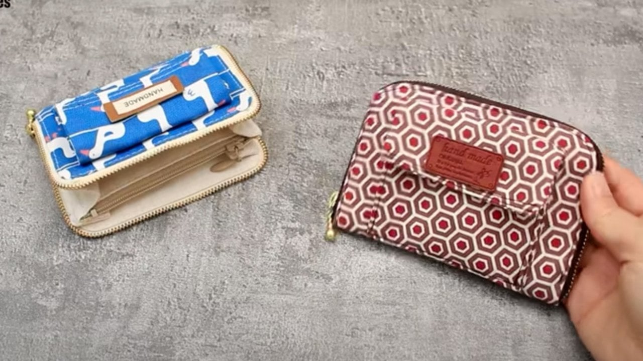 Zip around wallet, a blue and white patterned zip wallet open beside a closed red geometric print zip around wallet