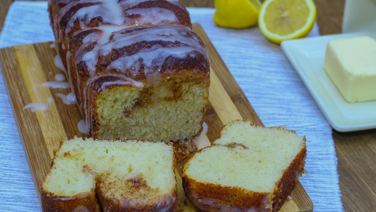 Dollywood cinnamon bread copycat with deep cinnamon sugar slits across the loaf and a white glaze drizzle