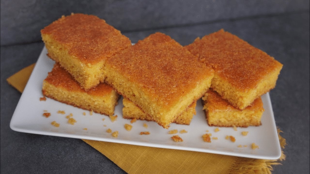 Easiest Honey Butter Cornbread Recipe Honey butter cornbread baked golden in a cast iron skillet with a glossy honey glaze brushed over the top
