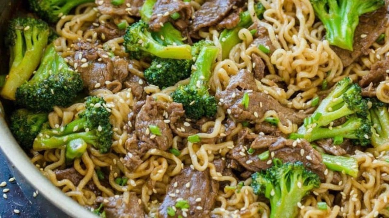 Beef and broccoli ramen stir fry with sliced flank steak, broccoli florets and noodles in a sauce ready to serve at home