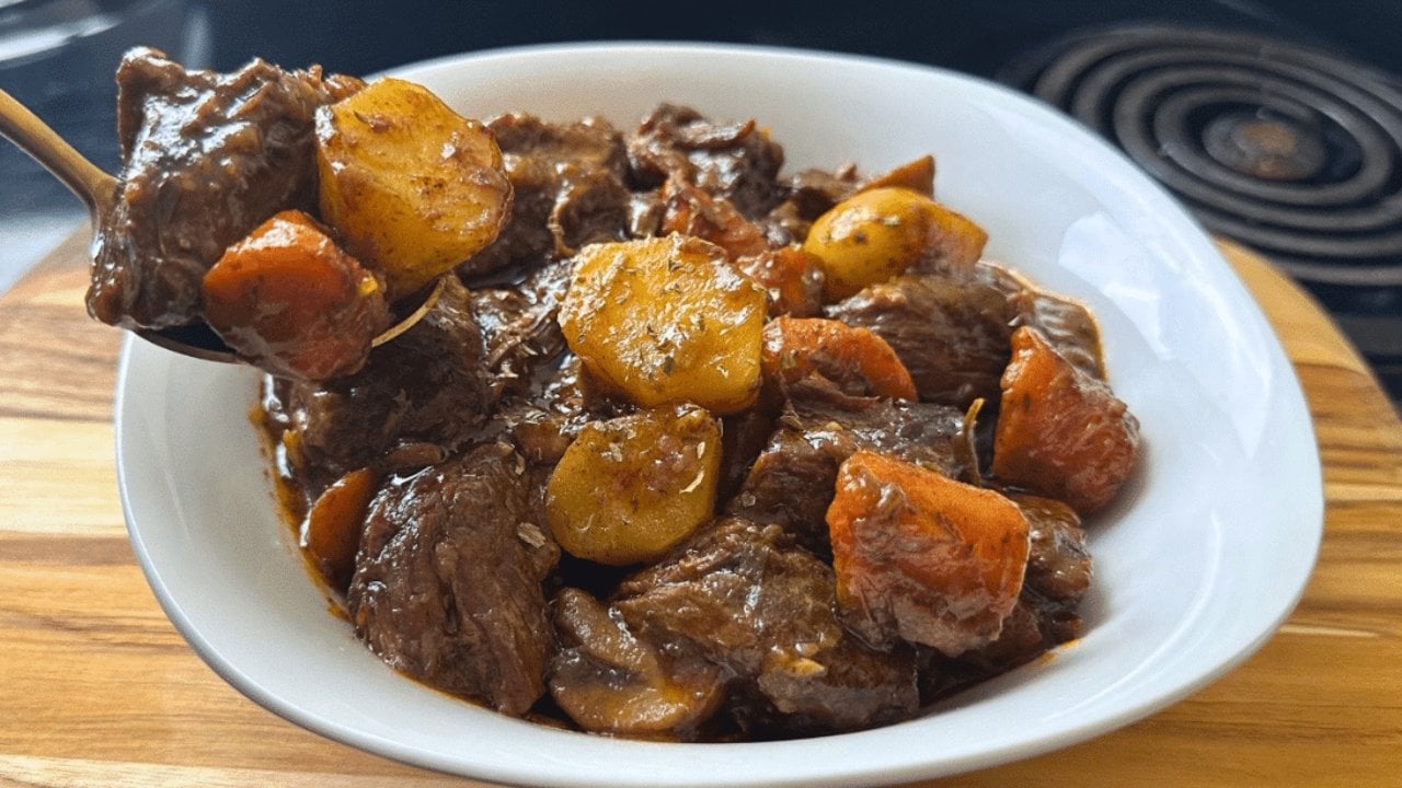 Award Winning Dutch Oven Beef Stew Beef stew simmered in a dutch oven with chuck roast, baby potatoes, mushrooms, carrots and dark beer