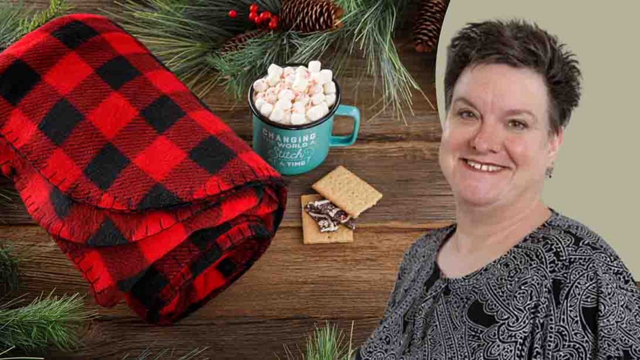 Easy blanket stitch fleece throw, a red and black buffalo check fleece blanket with a hand stitched black edge beside cocoa