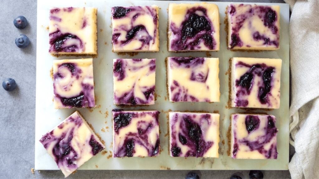 Easy Blueberry Swirl Cheesecake Bars, homemade and freshly served