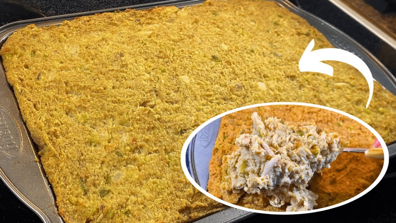 Easy chicken cornbread dressing baked in a dish with a browned top and visible celery, onion and sage
