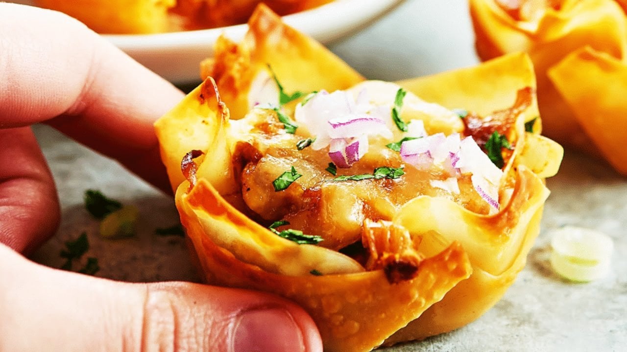 Chicken wonton cups baked in a muffin pan, filled buffalo style and barbecue style with green onion for a fast family dinner