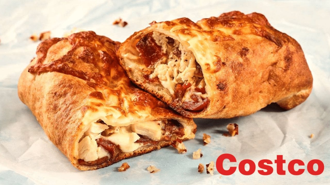 Copycat Costco chicken bake sliced open, pizza dough wrapped around chicken, bacon and Caesar sauce for a fast family dinner